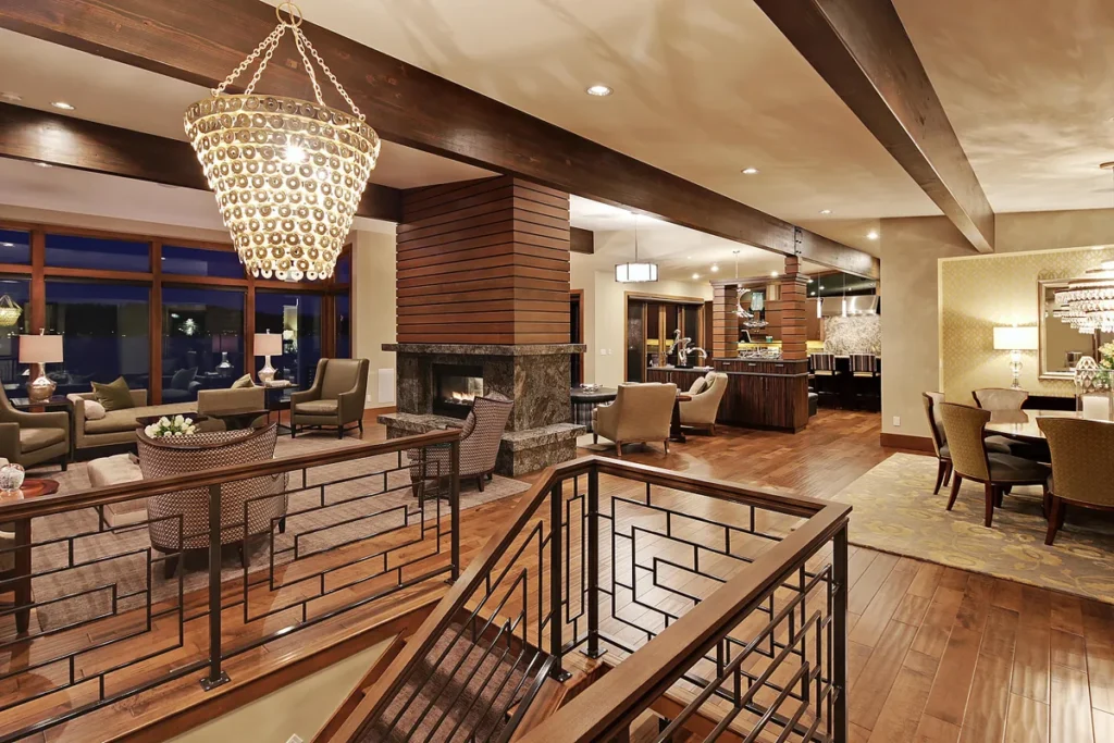Remodeled open living space with exposed wood beams, a statement chandelier, and a custom staircase in a Kirkland-area home by Piper Cole Architects.