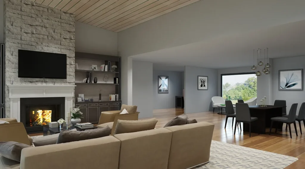 Open great room with a stone fireplace and wood-plank ceiling flowing into the kitchen and dining, a flexible multigenerational living space by Piper Cole Architects near Seattle.