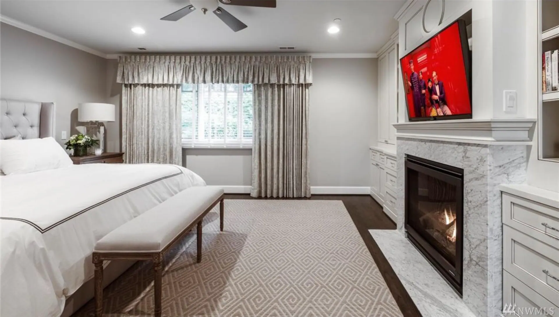 Medeiros Residence: primary bedroom with fireplace